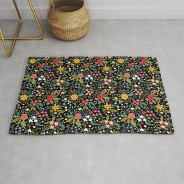 Amazing floral pattern with bright colorful flowers, plants, branches and berries on a black backgro Rug