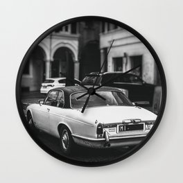 vintage jaguar car in vertical black and white background Wall Clock