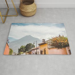 Colorful houses of a street in Antigua Guatemala with volcano views Rug
