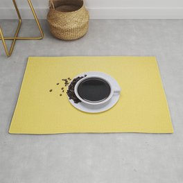 Black Cup of Coffee with Coffee Beans on Yellow Rug